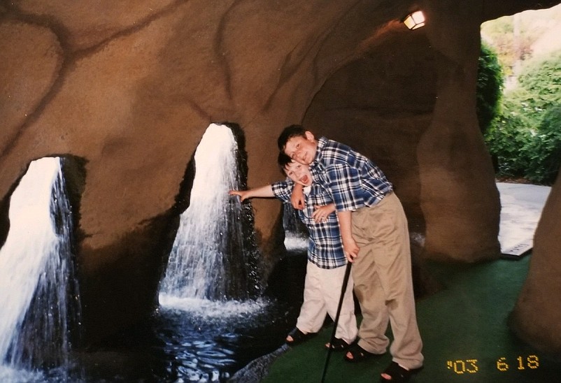 Tyler Onesty is pictured with his younger brother, Zach, while playing miniature golf in Maine in 2003. (Courtesy Sally Onesty)