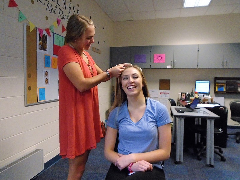 Mary Grace Jamison creates a hair masterpiece in a trial run on Bridget McMenamin for the prom.