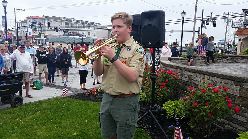 Bugler Jake Bryan, a Boy Scout, plays "Taps."