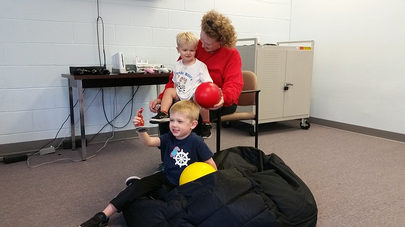 Sea Isle resident Arlene Burke is joined by her grandsons, Jack, 3, and Charlie, 2, in the old school's game room.