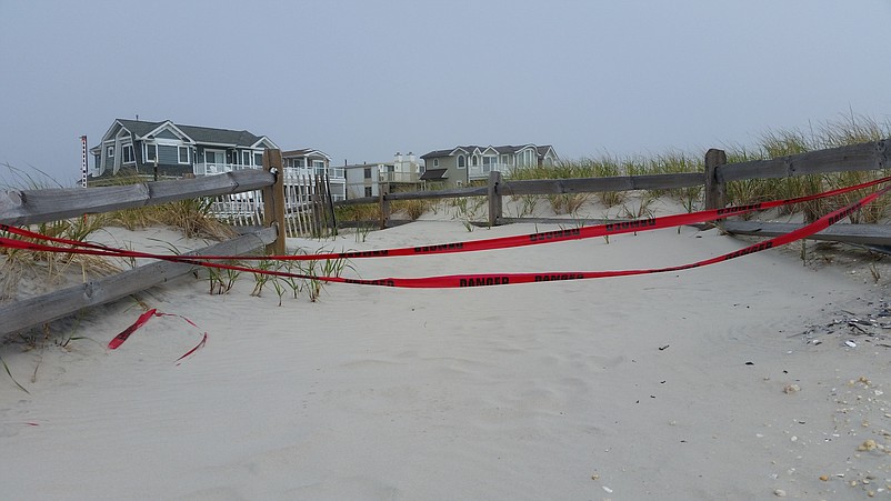 Red caution tape blocks the way where the dunes were damaged at 89th Street.