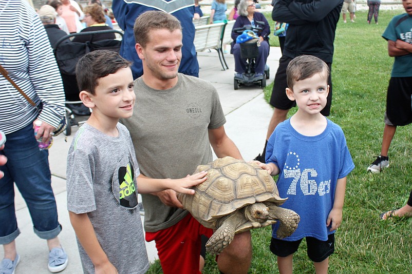 A representative from New Jersey Nature shows a turtle to children at the 2018 Sara the Turtle Festival at Sea Isle’s Excursion Park.(Courtesy Sea Isle City)