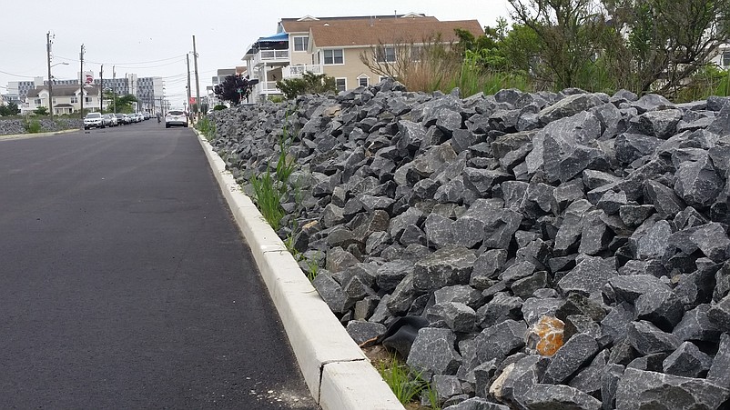 More rock walls, like this 4-foot-high barrier lining 38th Street near the bay, should be built in Sea Isle to block stormwater, the flooding study recommends.