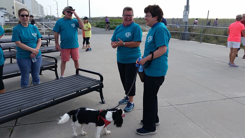 Joined by her dog, Beverly, Cape May County Clerk Rita Marie Fulginiti shares a laugh with other walkers.