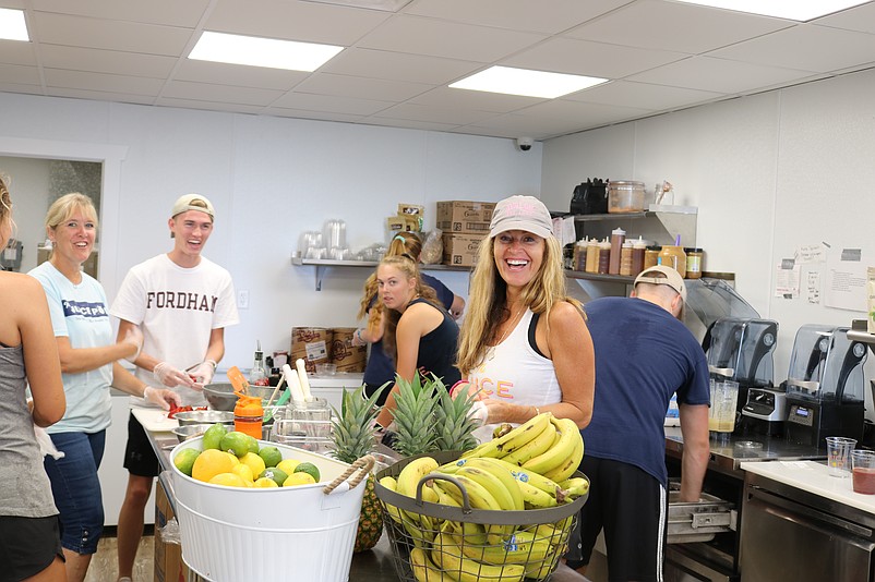 Danielle Leonhardt jokes with employees at the Juice Pod. 