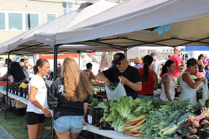 Shoppers enjoy Sea Isle's Farmers Market at Excursion Park Tuesday morning.