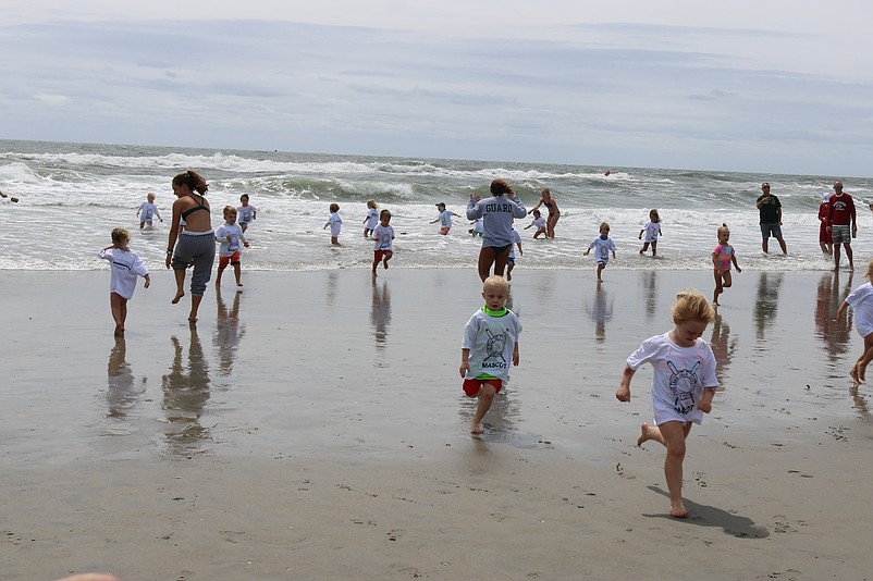 Little mascots enjoy a race to the water.