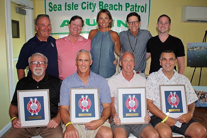 (Image: SICBP Alumni Board and Inductees) Shown during this year’s Sea Isle City Beach Patrol Alumni Association Hall of Fame Dinner are (standing, from left) Alumni Board Public Relations Chairperson Wayne MacMurray, President John McCann, Treasurer Joanne Lombard Palumbo, Vice-President Tim McNamara and Secretary Dan McCann with (seated from left) Tom Flud, who accepted the posthumous award for 2018 Hall of Fame Inductee John Coleman, and 2018 Hall of Fame 