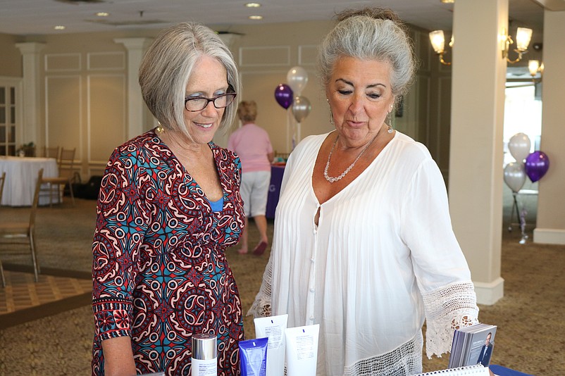 Lee Neuman, of Cape May Court House, and friend Gene Palm, of Rio Grande, look at some skin care products.