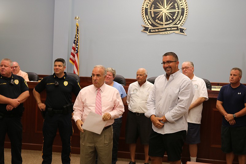 Tom D'Intino, right, acknowledges his family members in the audience, thanking them for their support during his career in law enforcement.