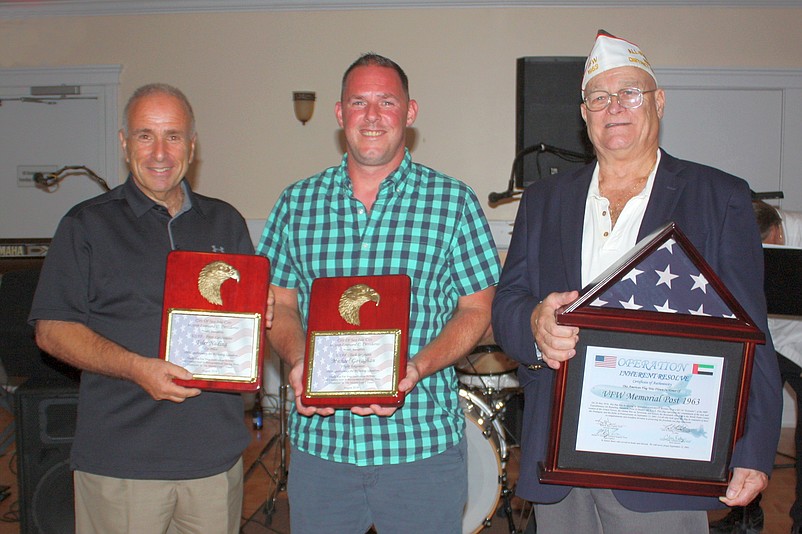 U.S. Air Force Tech Sgt. Michael Gavaghan, center, of Holland, Pa., and Sea Isle City, donates an American flag to Mayor Leonard Desiderio and VFW Post 1963 Commander Charles "Chick" Haines. 