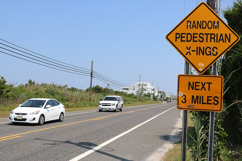 Pedestrians also share space with cars and trucks on the narrow three-mile corridor.