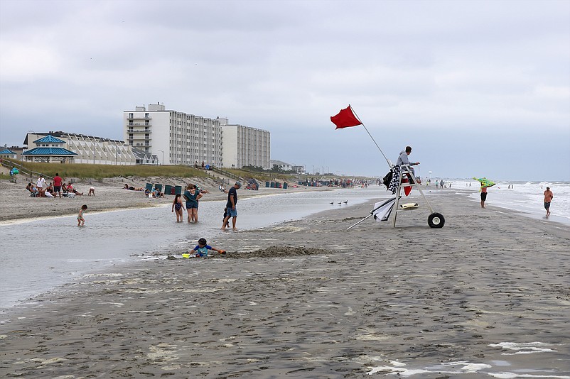 Red flags warned swimmers to only go in up to their knees.