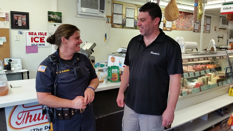 Sgt. Misty Elgersma and Giovanni's owner John Libro share a light moment.