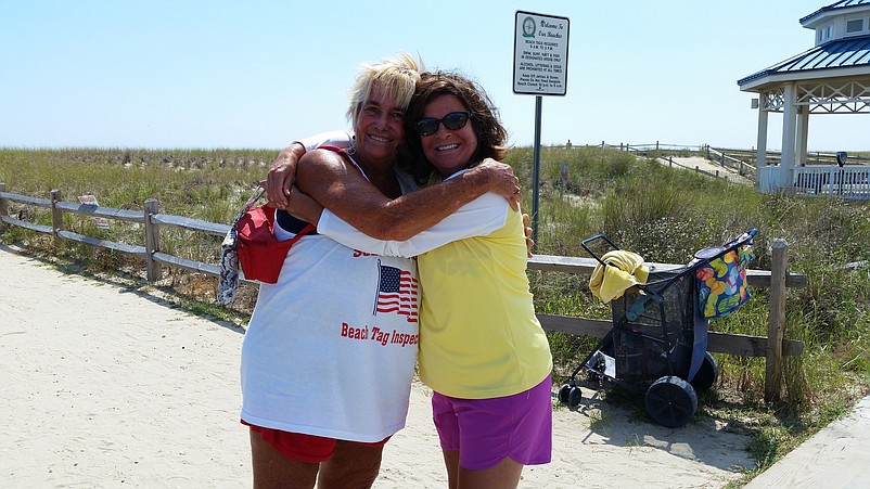 Sea Isle beach tag inspector Kathy McFarland, left, and summer resident Laura Lochetta share a goodbye hug to close the Labor Day weekend.