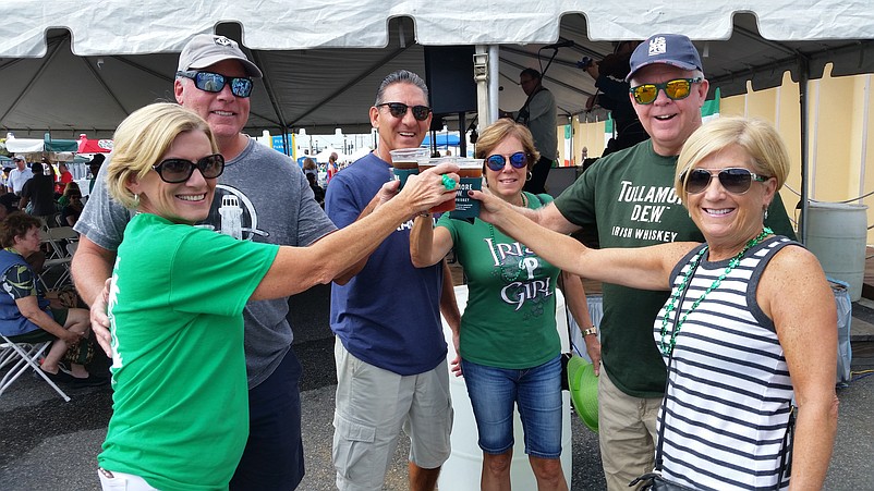 From left, festival-goers Cheryl Chestnut, Michael Chestnut, Lou Manfre, Beth Gavin, Fran Gavin and Ann Manfre celebrate with a toast of Guinness beer.