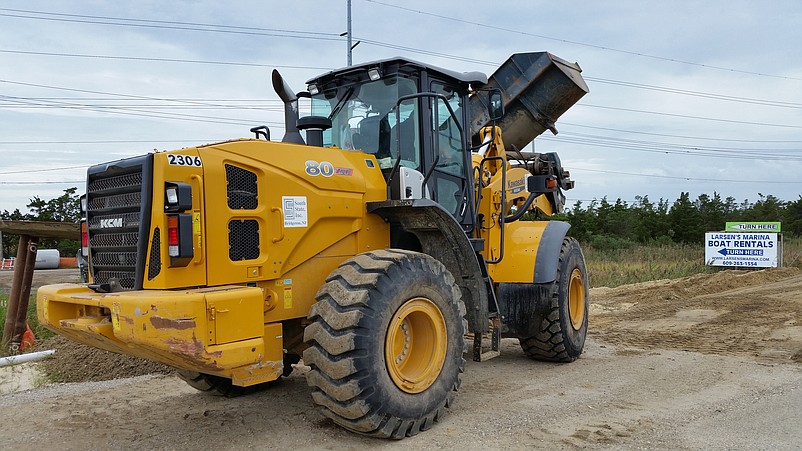 A big earthmover is part of the heavy construction equipment being used to build a new flood-proof elevated section of Sea Isle Boulevard.