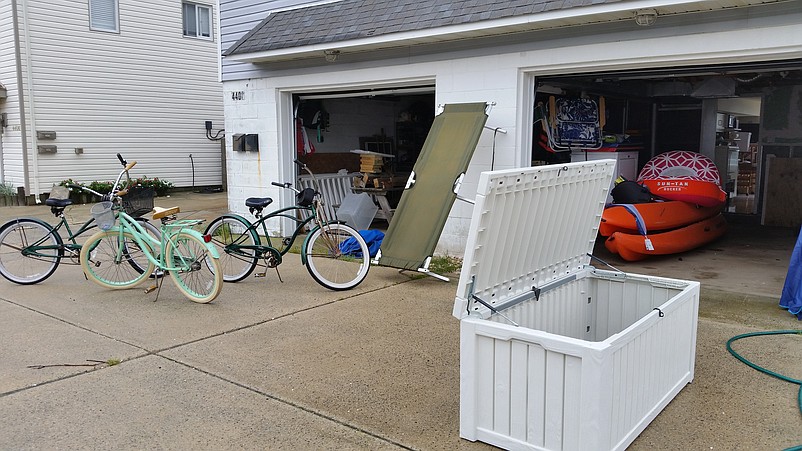 Jeff and Jeanette Beshel pulled bicycles, a cot and a cooler out of the waterlogged garage at 4400 Venicean Road while cleaning it.