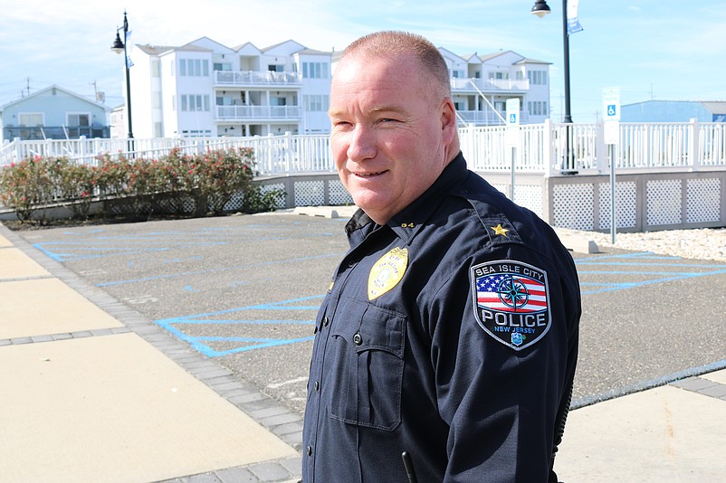 Sea Isle Police Chief Tom McQuillen displays the new badge that pays homage to fallen city officer, Mickey Cullinane. 