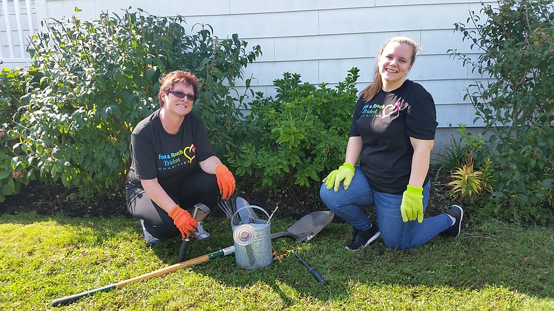 Sales agent Jackie Malench, left, of Vineland, and rental coordinator Sarah Gattis, also of Vineland, take a break from pulling weeds in the church shrubbery.