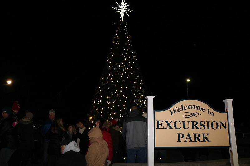 The towering holiday tree in Excursion Park is lighted as part of the festivities.