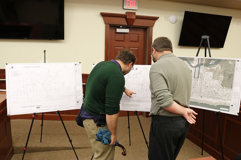 Landis Avenue resident Ross Tippin, left, reviews a map of Sea Isle with Christopher Eaton, a project manager with Maser Consulting P.A., the firm that conducted the flooding study.