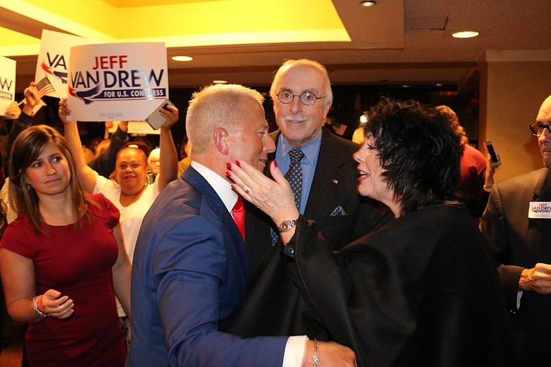 Van Drew receives congratulations from Sea Isle City attorney Beverly McCall, while her husband, Frank McCall, looks on.