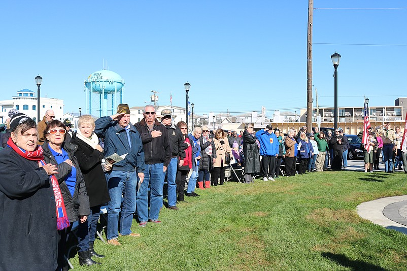 The crowd stands for the Pledge of Allegiance. 