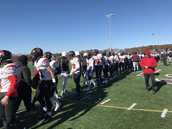 Raiders congratulate Pleasantville players after they defeated the Raiders 20-7 on Thanksgiving morning.