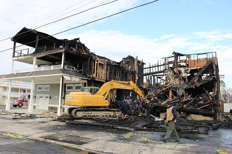 An excavator demolishes the charred rubble of the duplex where Marie Zielinski had lived on 54th Street.