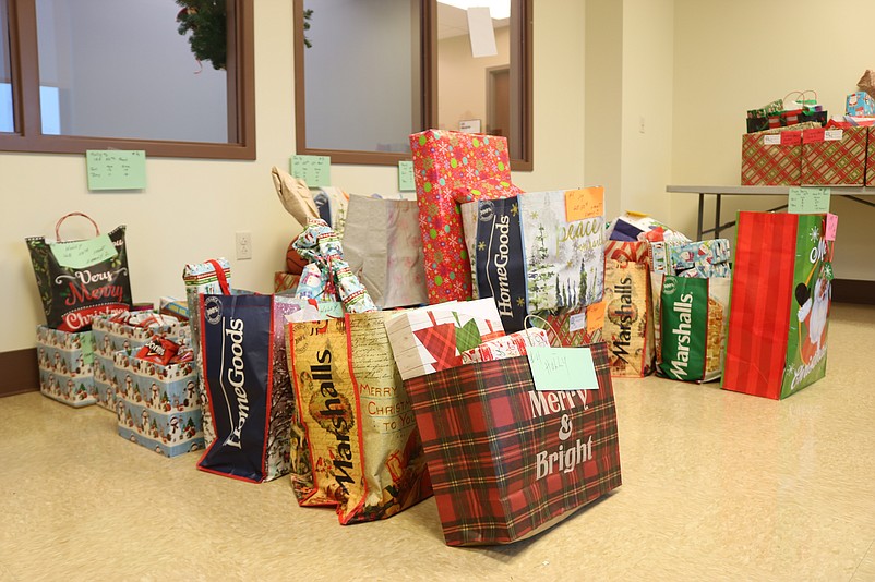 Bags and boxes of Christmas gifts and food are stored in a room at City Hall.