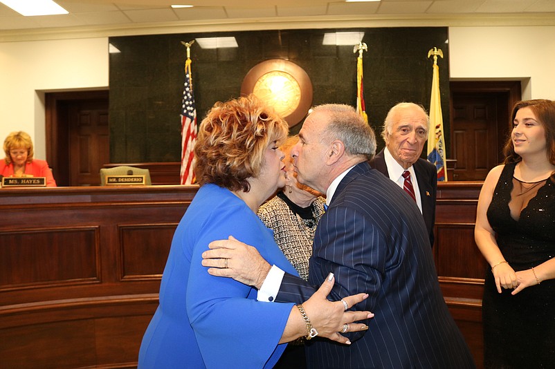 Desiderio gives a celebratory kiss to his wife, Carmela.