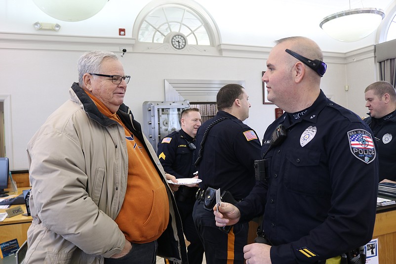 Resident Rick Weiner chats with Sea Isle Office Hank Frank during Monday's "Coffee With a Cop" event at 1st Bank of Sea Isle City.