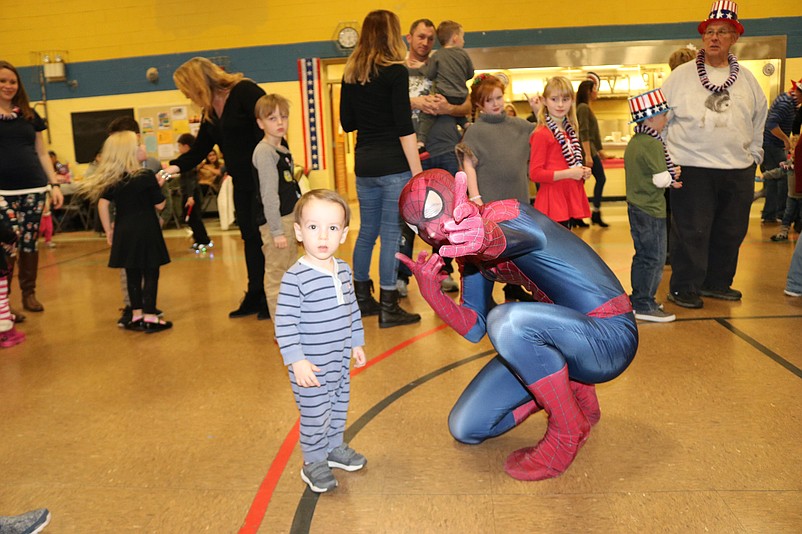 Spider-Man hams it up with one of his fans, 18-month-old Brody Opuszynski, of Ocean View.