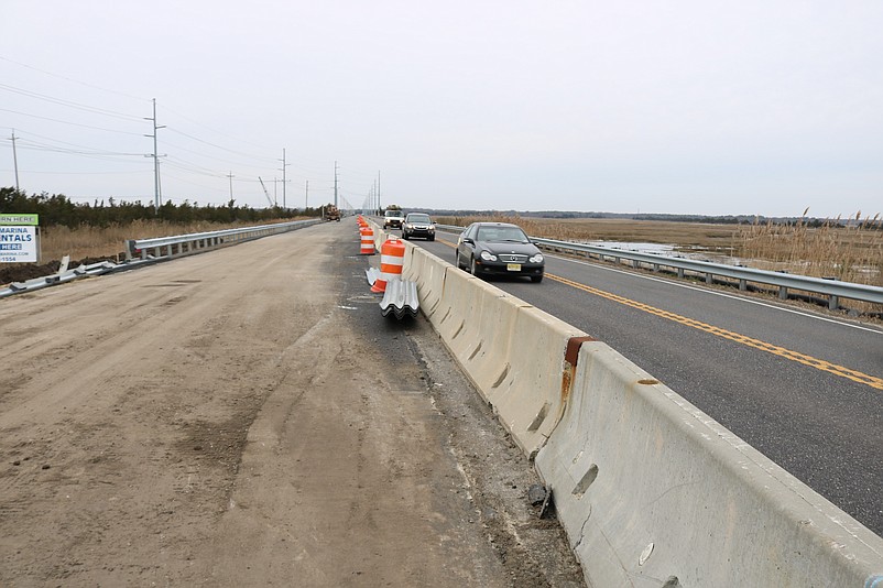 This view shows the new road taking shape on the left behind the construction barrier.