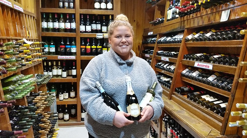 Jess Lynch, a clerk at the Kix-McNutley's liquor store, shows off some holiday favorites.