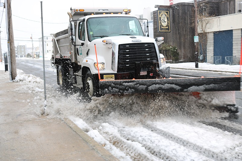 A Sea Isle City municipal snowplow clears the road during a snowstorm.