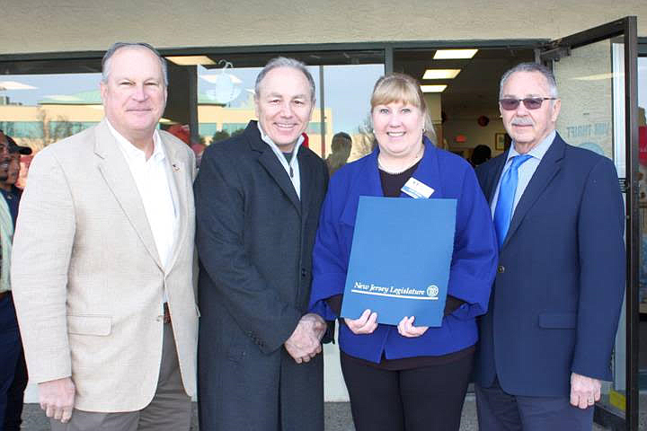 During the Grand Opening of the new Volunteers in Medicine of South Jersey Thrift Store in Egg Harbor Township on January 26, NJ State Assemblyman Vincent Mazzeo (second from left) and Assemblyman John Armato (far right) presented a Joint Legislative Proclamation to the members of VIM, which was accepted by VIM Executive Director Jackie Meiluta. Also shown during the presentation is Egg Harbor Township Mayor Paul Hodson (far left), who had the honor of cutting a ceremonial ribbon to officially open Atlantic County’s newest thrift store.  