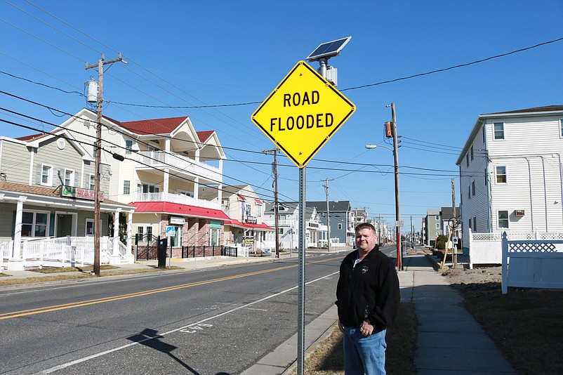 Brian Teefy, Sea Isle's traffic maintenance supervisor, stands next to one of the new "Road Flooded" signs flash when stormwaters threaten the town.