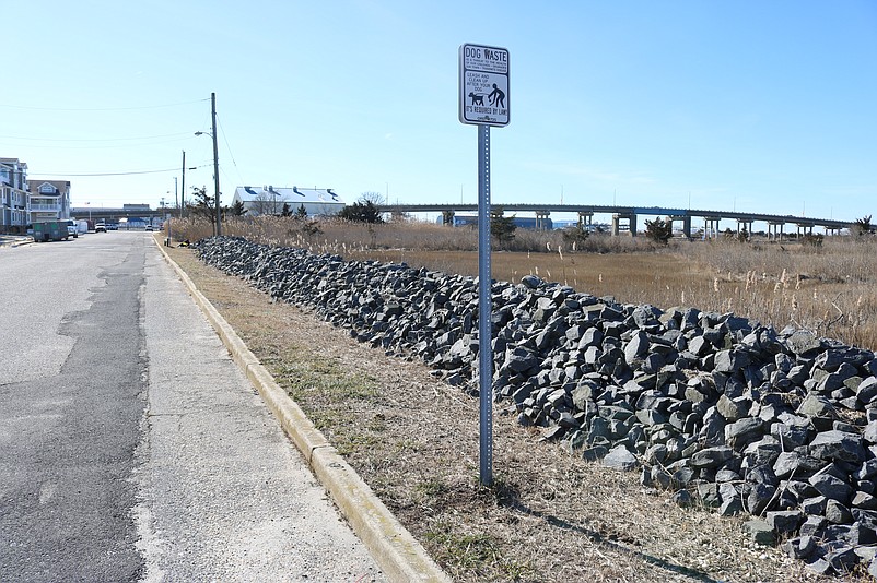 A waist-high rock wall in Sea Isle City at the bay end of 38th Street serves as a barrier to keep stormwater from surging out of the marshlands.