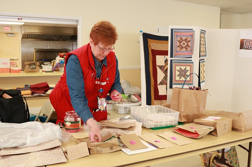 South Jersey Quilts of Valor Foundation member Ruth Ann Bosworth calls out the raffle winners.