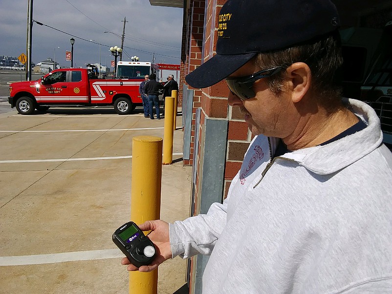 Assistant Fire Chief Mike Tighe demonstrates the carbon monoxide detector machine firefighters use to cage the air in homes during alarms.