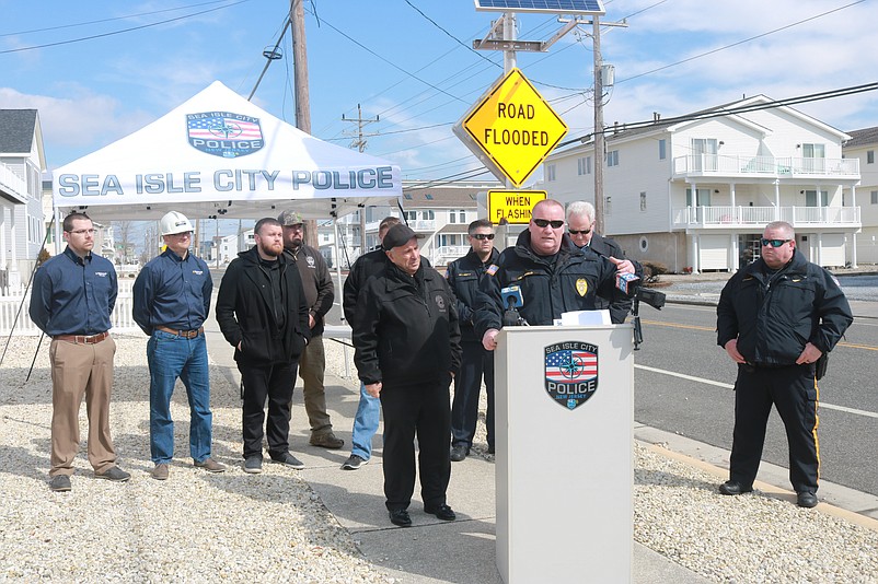 Police Chief Tom McQuillen, along with Mayor Leonard Desiderio, at left by podium, were among the officials at the unveiling of the flood warning system in March.