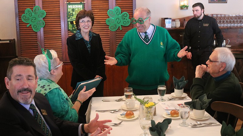 Mayor Leonard Desiderio gets a jump start on St. Patrick's Day at an AARP luncheon Thursday. County Clerk Rita Fulginiti smiles. 