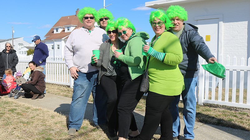 Spectators Jennifer and Andrew Wiess, Gina and Craig Hodnett and Vickie and Gijs Van Verplas, all of Pennsylvania, decked out in green wigs for the 2019 parade.