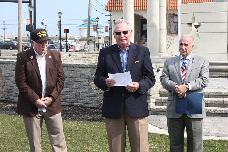 Vietnam veteran Michael Rodgers speaks during  last year’s National Vietnam War Veterans Day ceremony in Sea Isle City while fellow Vietnam veteran and state Assemblyman R. Bruce Land, left, and Mayor Leonard Desiderio listen.