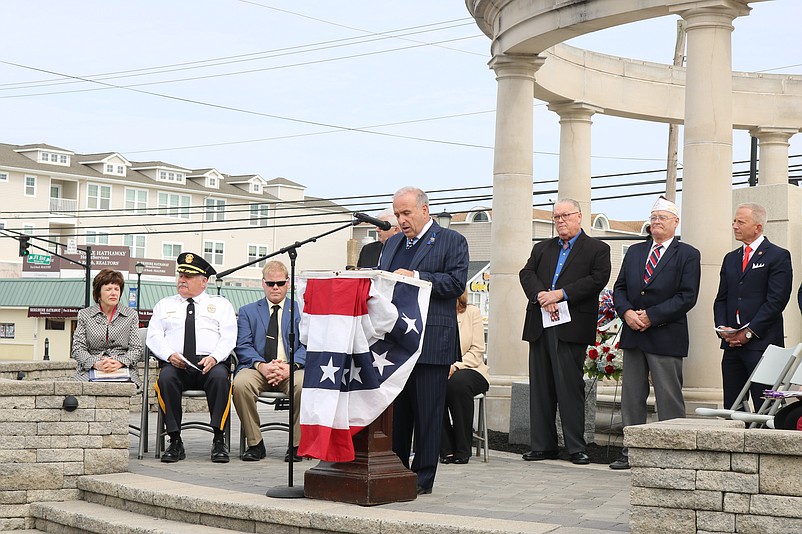 Mayor Leonard Desiderio is the master of ceremonies in the somber ceremony.