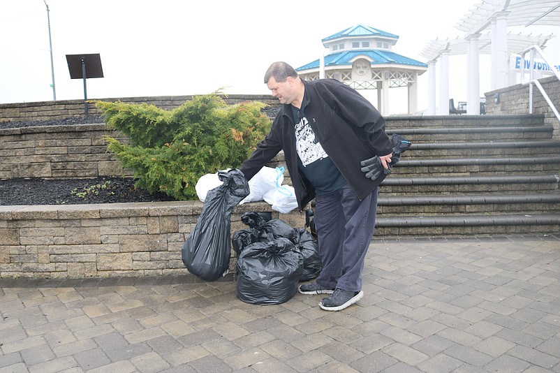 Volunteer Jim Knipp, of Cape May Court House, drops off a bag of trash that he collected in April's beach sweep.