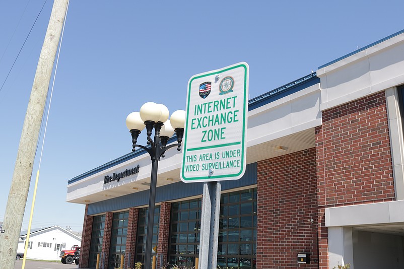 The sign notes that the "Internet Exchange Zone" in front of City Hall is monitored by surveillance cameras.