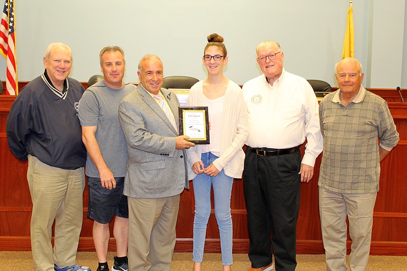 Lily Capone is honored, from left, by Councilman William Kehner, Councilman Frank Edwardi, Mayor Leonard Desiderio, Councilman J.B. Feeley and Council President Jack Gibson. (Courtesy of City of Sea Isle City)